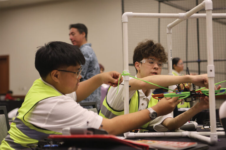 Two students working on a drone.