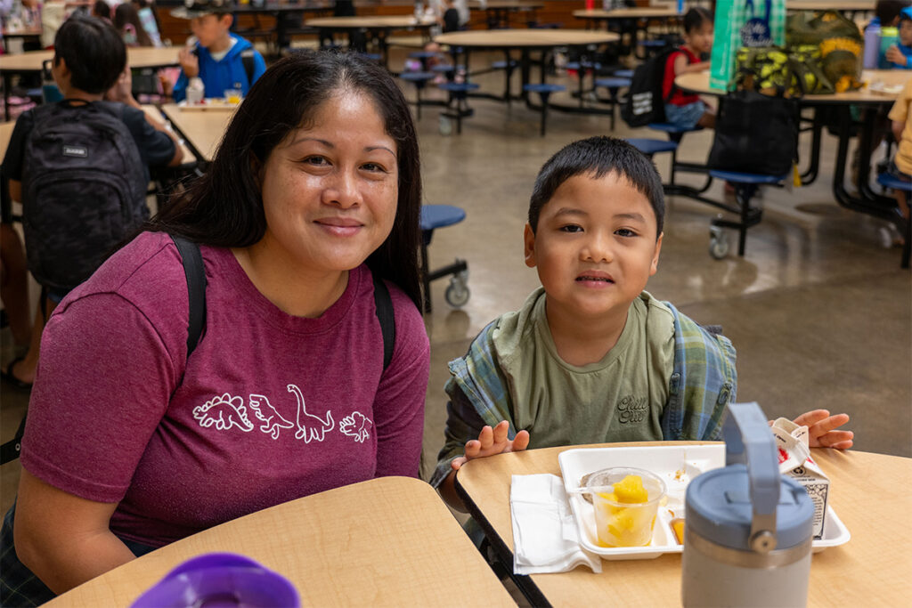 Mother and son who is eating breakfast