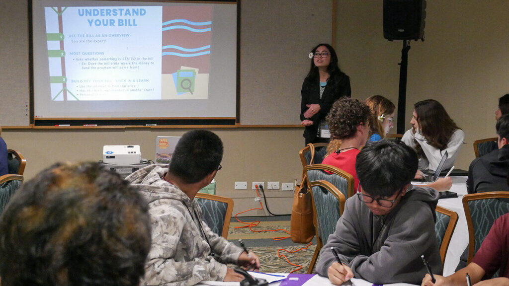 Secondary Student Conference attendees listen during a session about legislative bills.