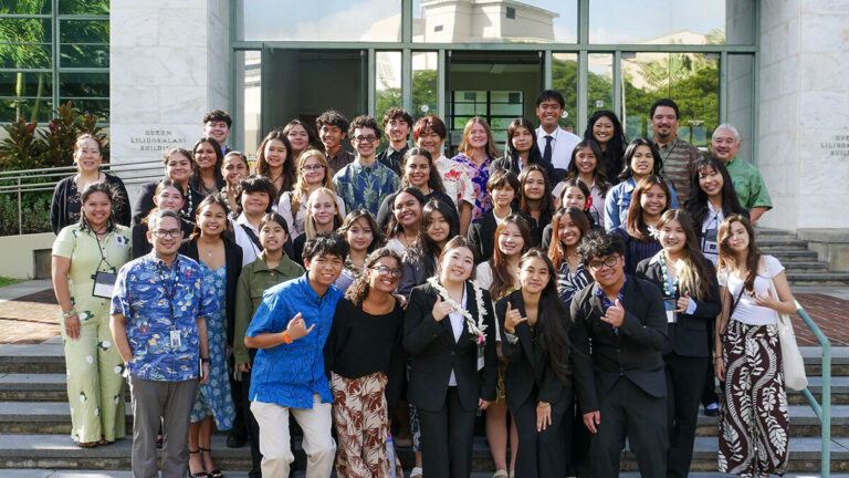 Secondary Student Conference attendees pose for a group photo in front of the Department of Education.