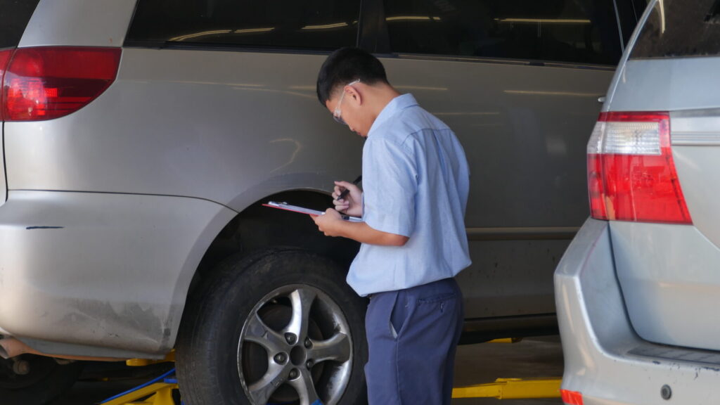 A student examines a car during a CTSO event.