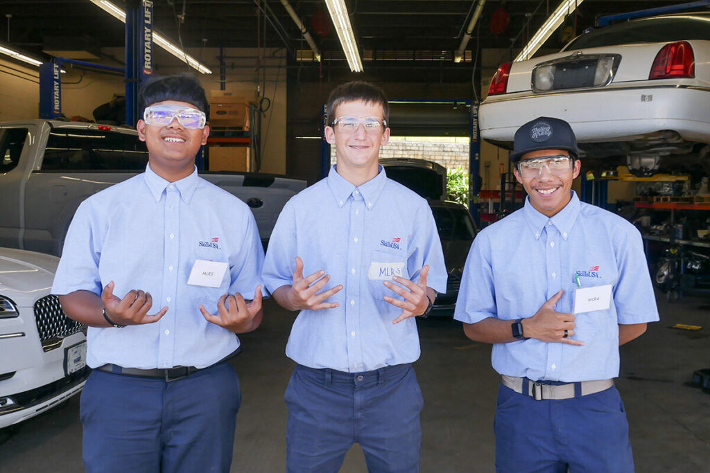 Automotive students flash a shaka during their CTSO competition.