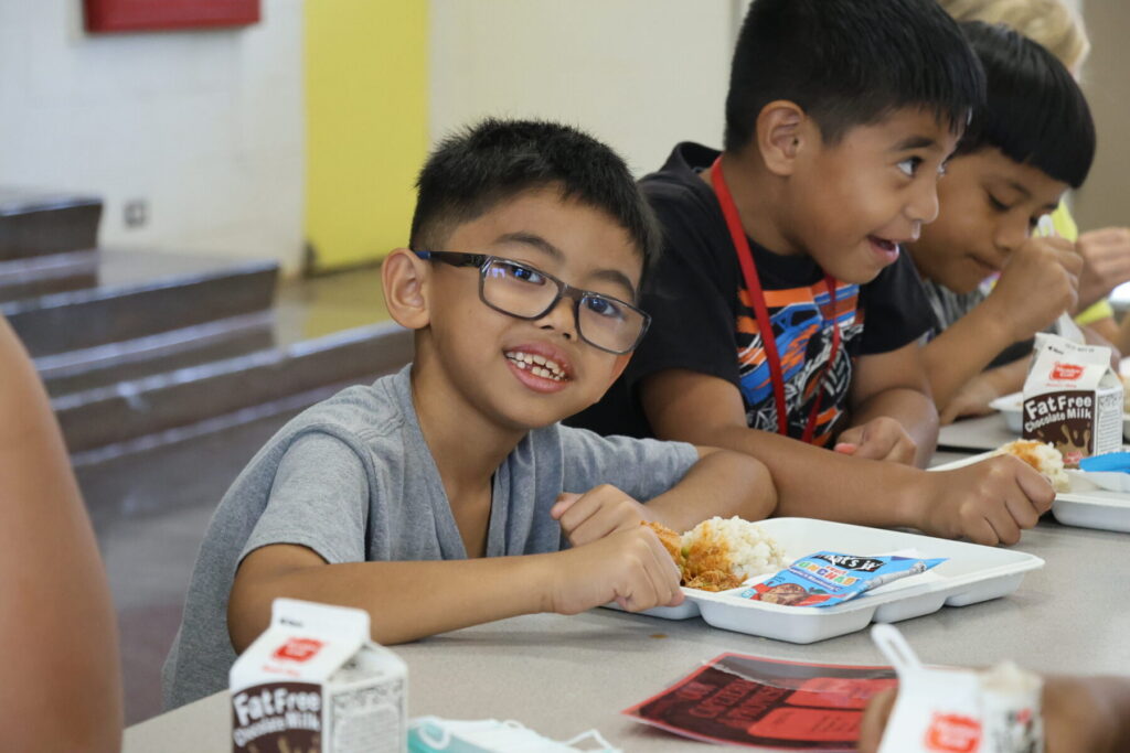 Student smiling while eating