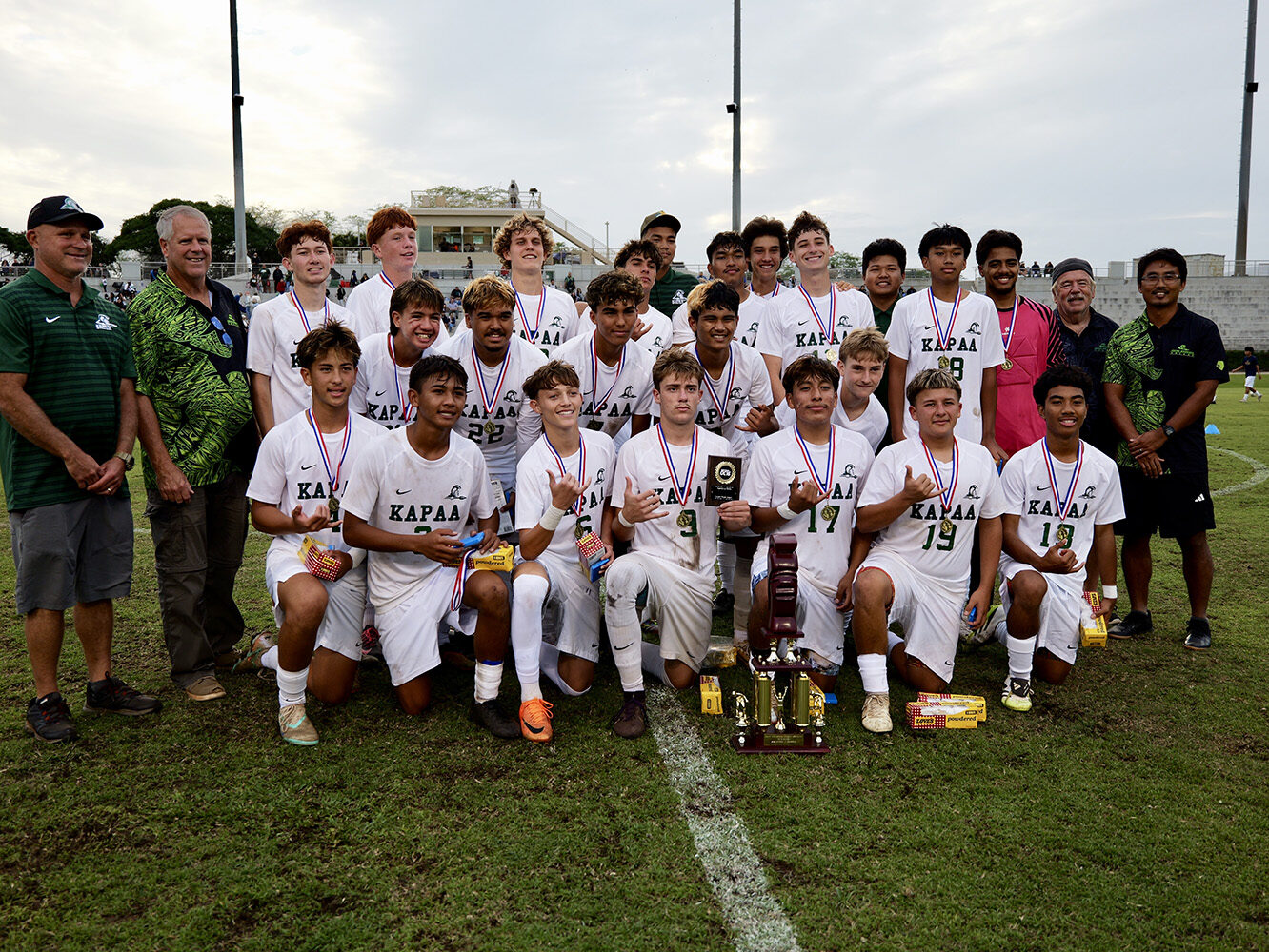 The Kapa‘a boys soccer team with the championship trophy after winning the Division II state title.