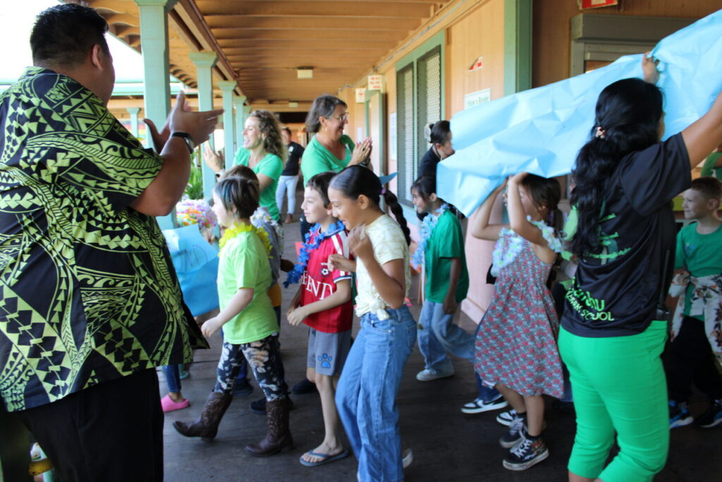 Students and teachers perform a run activity for the first day back to school.