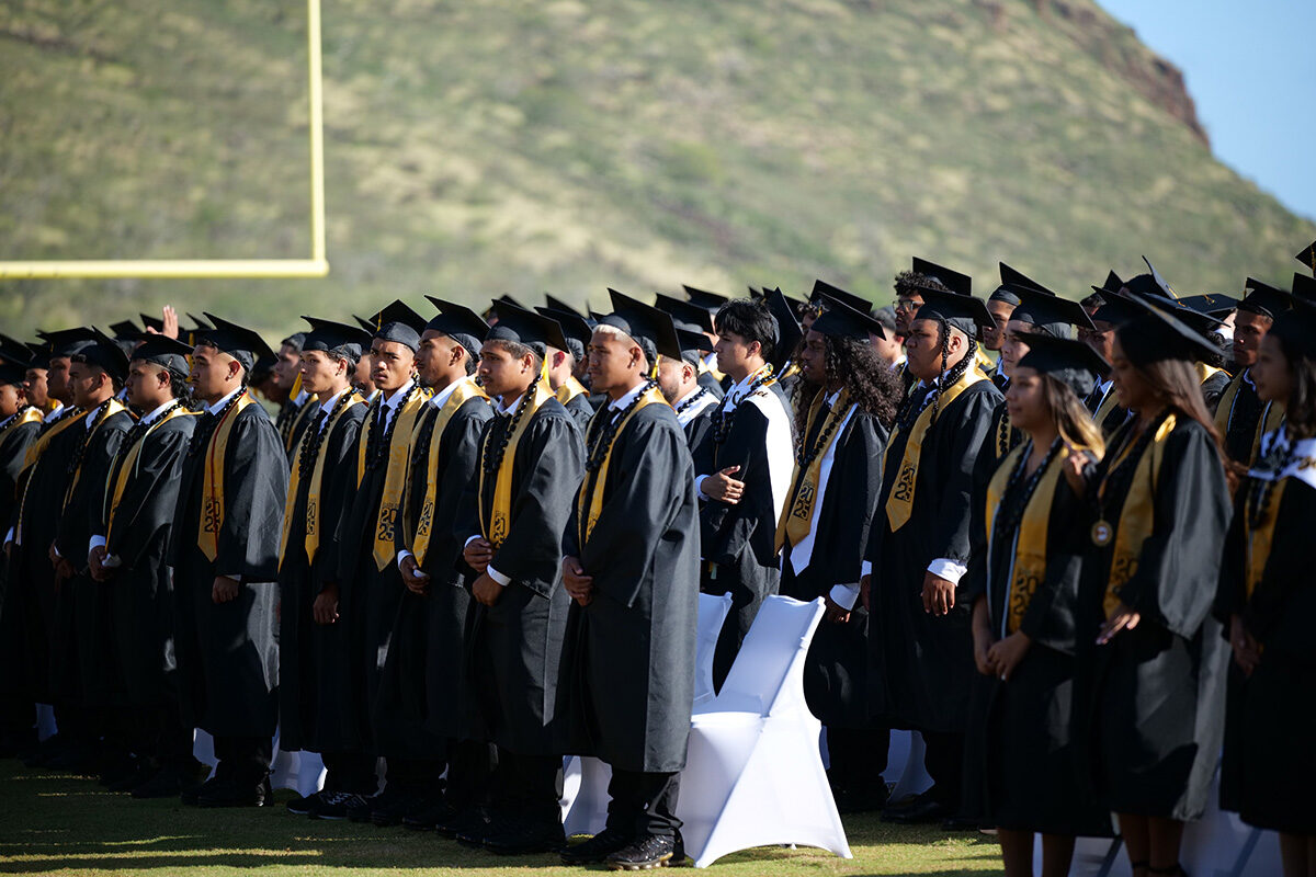 Graduates stand during Nanakuli's commencement ceremony.
