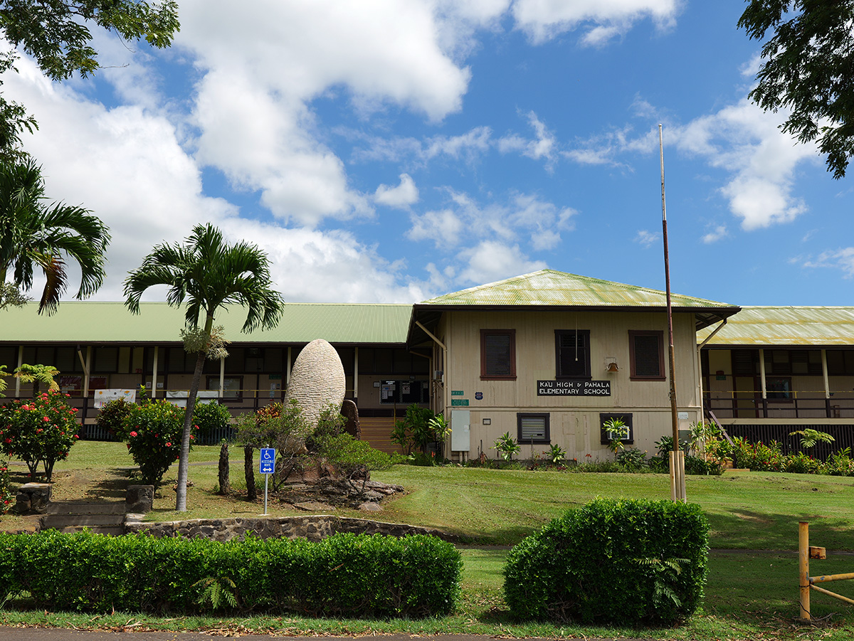 A building on the campus of Ka‘ū High and Pāhala Elementary School with plants in front of it.