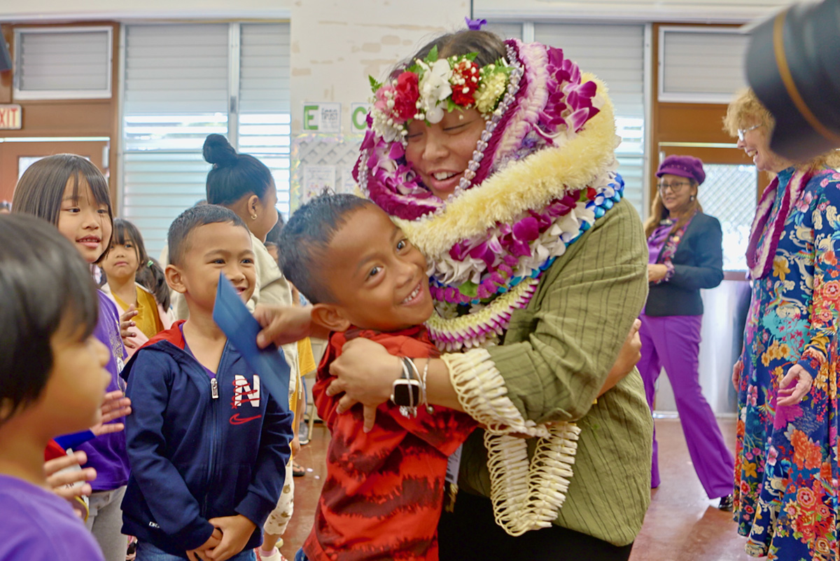 Teacher Kristy Inamasu gets a hug from a student.