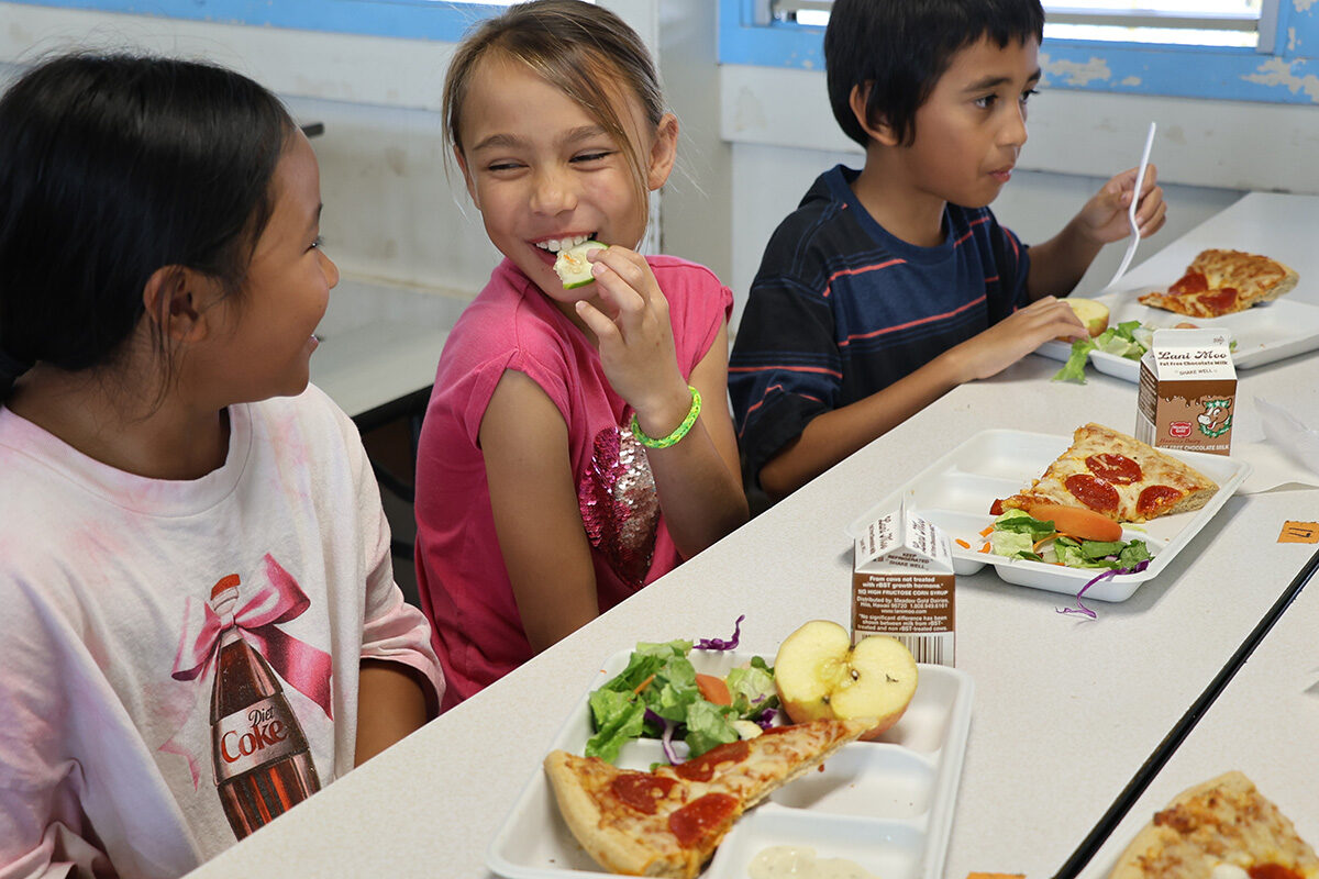 Students enjoy their lunches in the cafeteria.