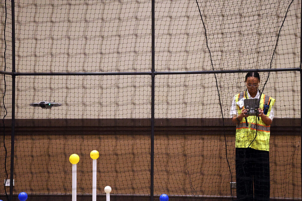 A student watches a drone fly during a CTSO event.