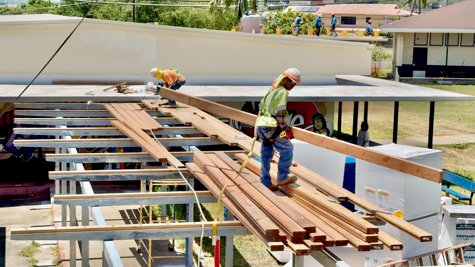 Crews construct one of three new covered walkways at ʻAiea Elementary over the summer break.