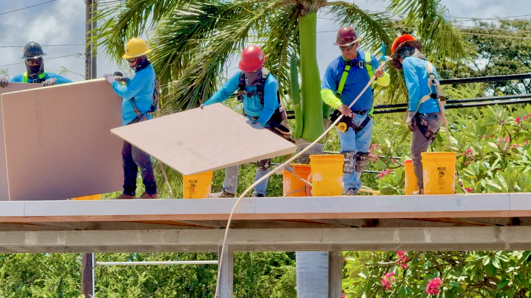 Crews construct one of three new covered walkways at ʻAiea Elementary over the summer break.