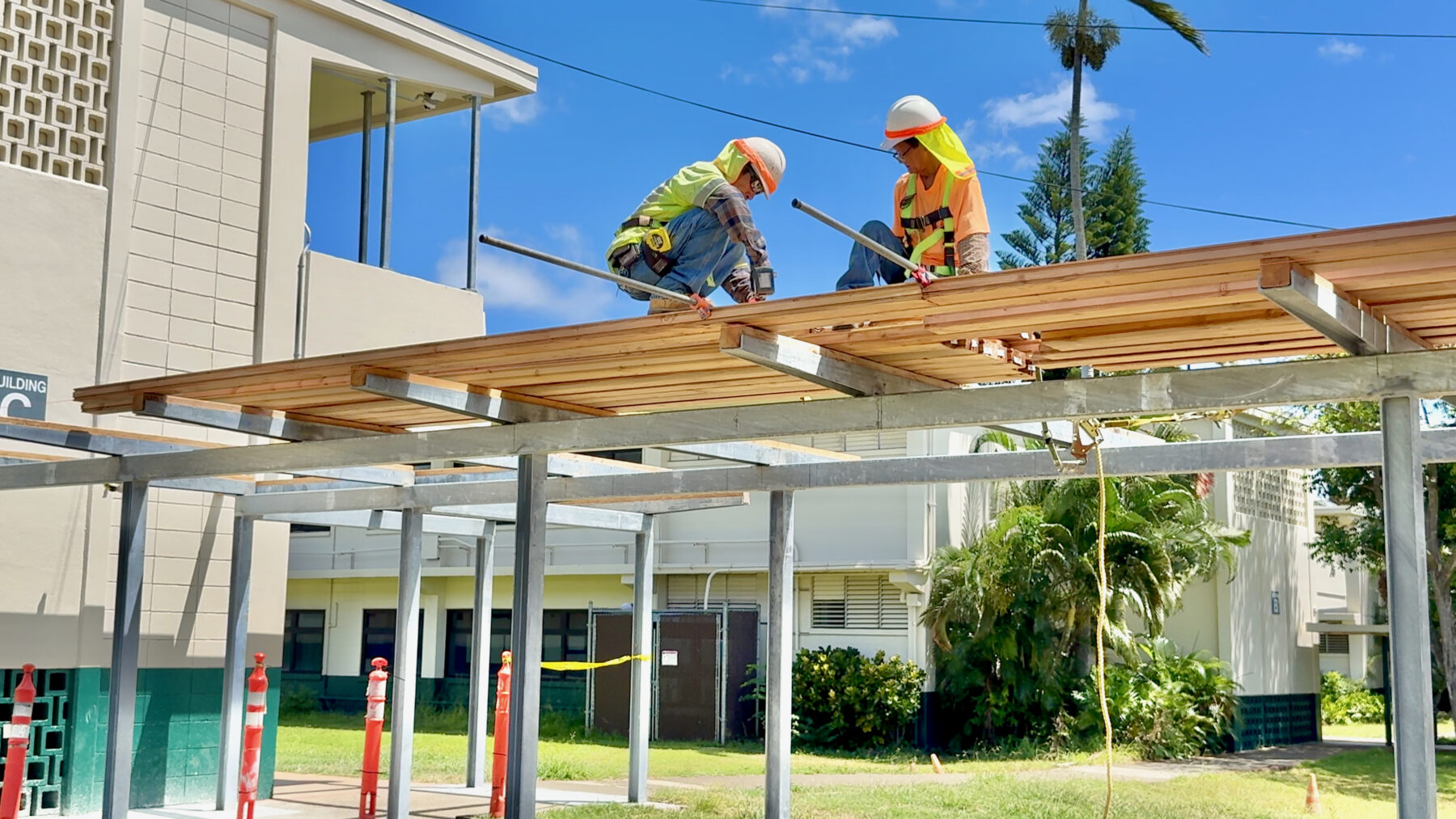 Crews construct one of three new covered walkways at ʻAiea Elementary over the summer break.