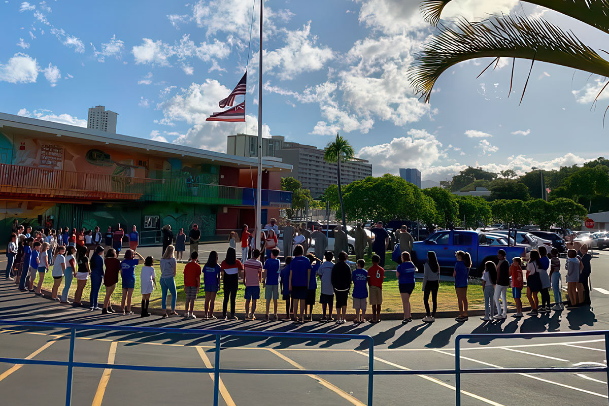 flags being raised, students standing in a circle