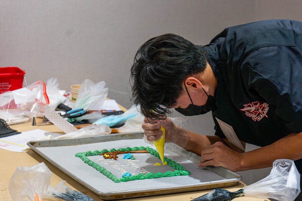 A student participates in the cake decorating event.