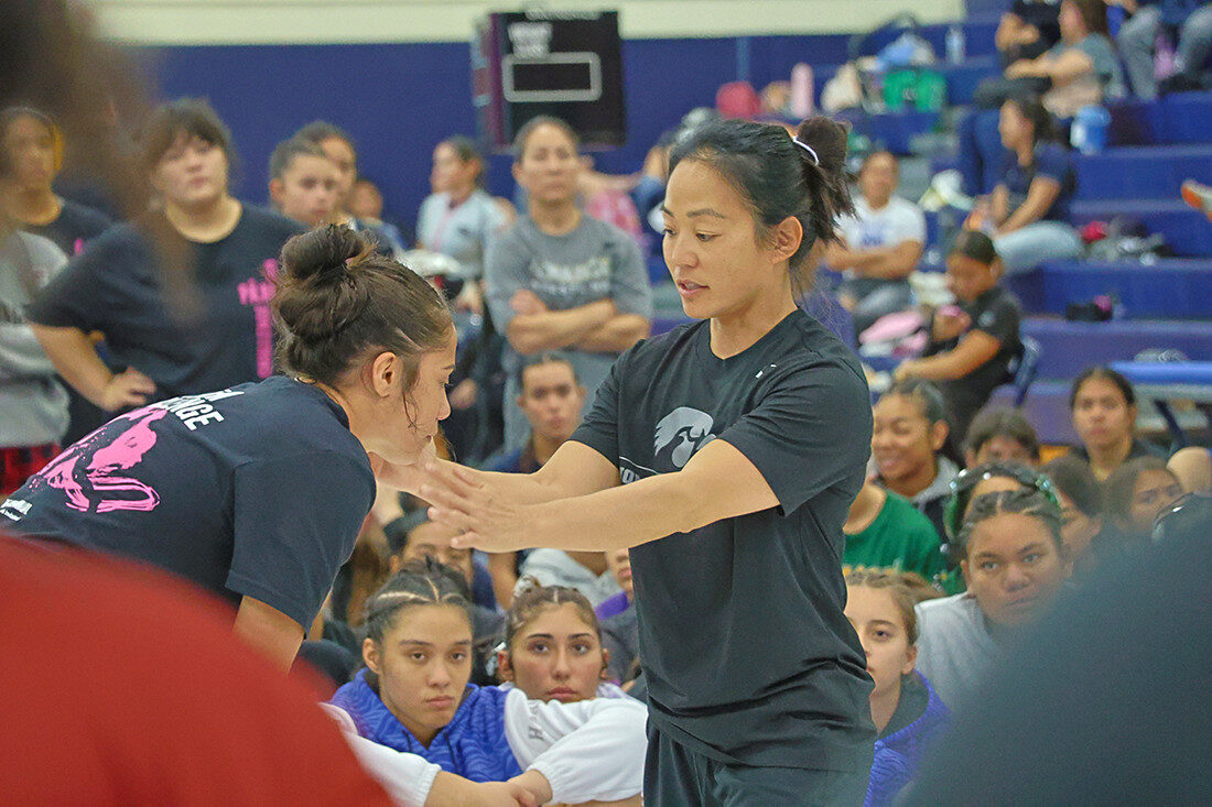 Roosevelt High alum Clarissa Chun, right, hosted a wrestling clinic for 450 female high school wrestlers at the 14th annual Pāʻani Challenge, a statewide girls wrestling event at Kamehameha Schools Kapalama on Dec. 26. Photo credit: Kimberly Yuen / HIDOE Communications Branch