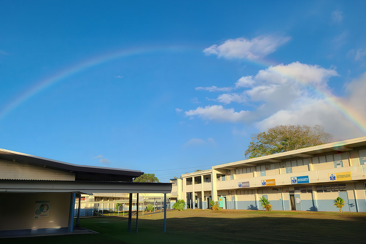 school buildings with rainbow in background