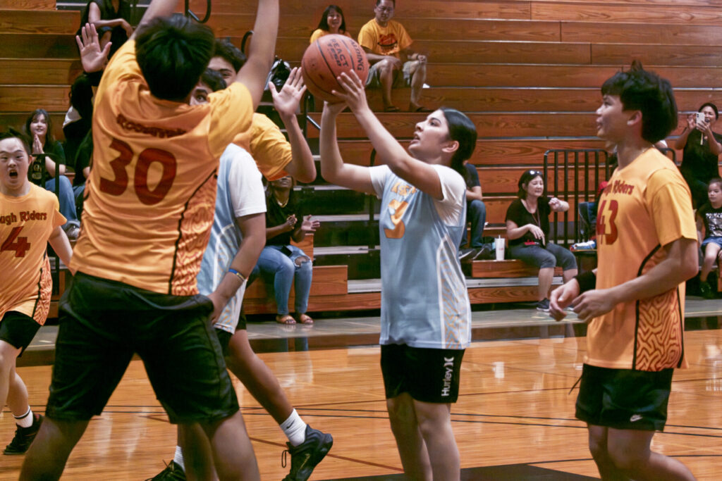 Student shooting basketball