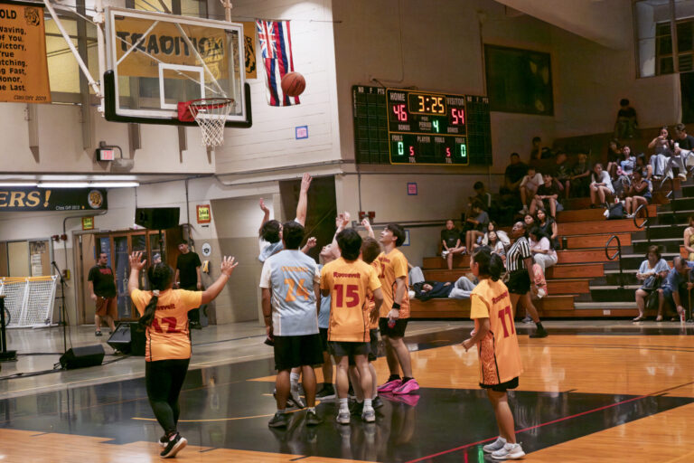 Student shoots basketball