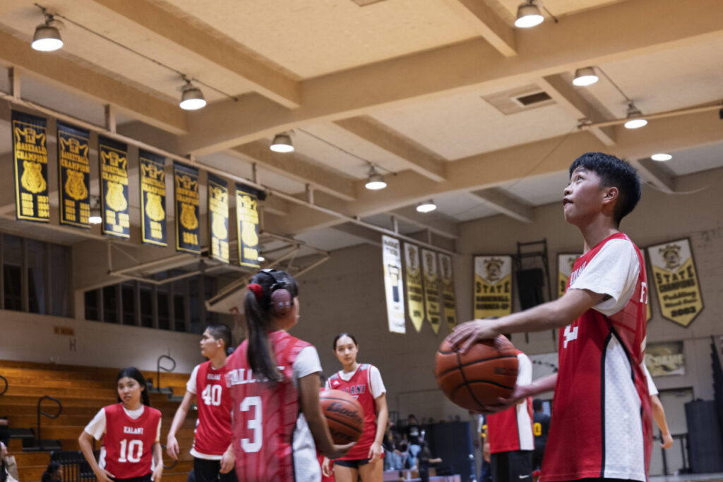 Student shoots basketball