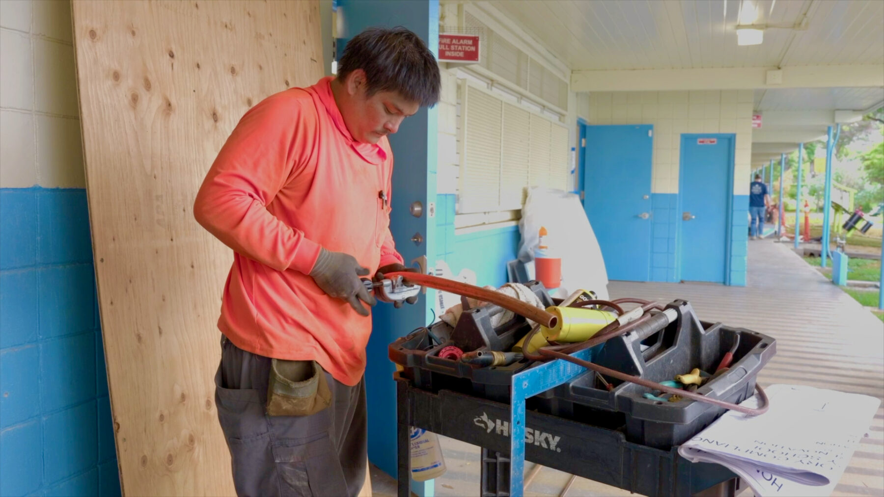 Plumbing repairs are underway with workers preparing copper pipes at Hōkūlani Elementary School during the summer break.