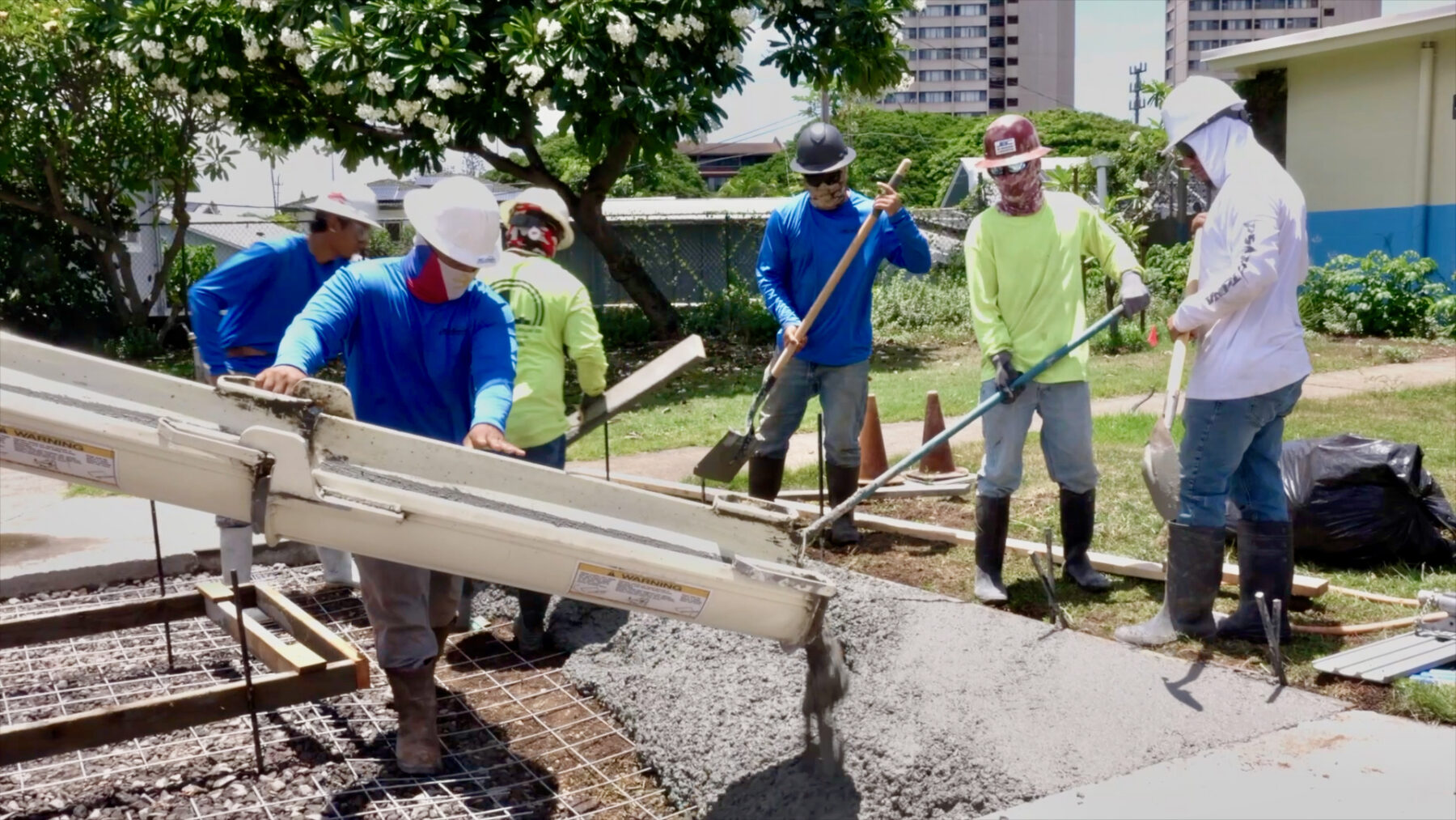 Concrete is poured for sidewalk improvements at Hōkūlani Elementary School during the summer break.