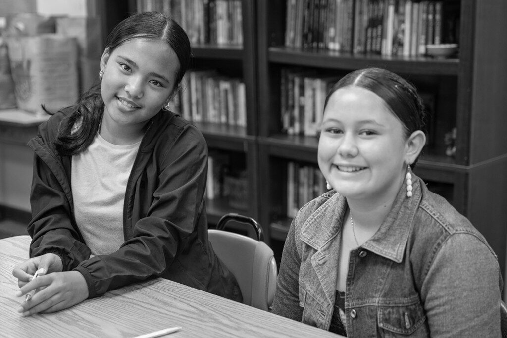 Two students smiling