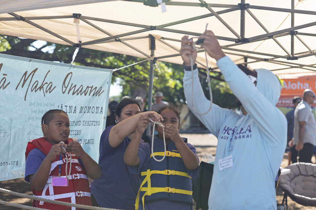 Students learn to tie a knot.