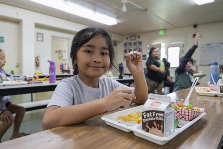 student eating vegetables
