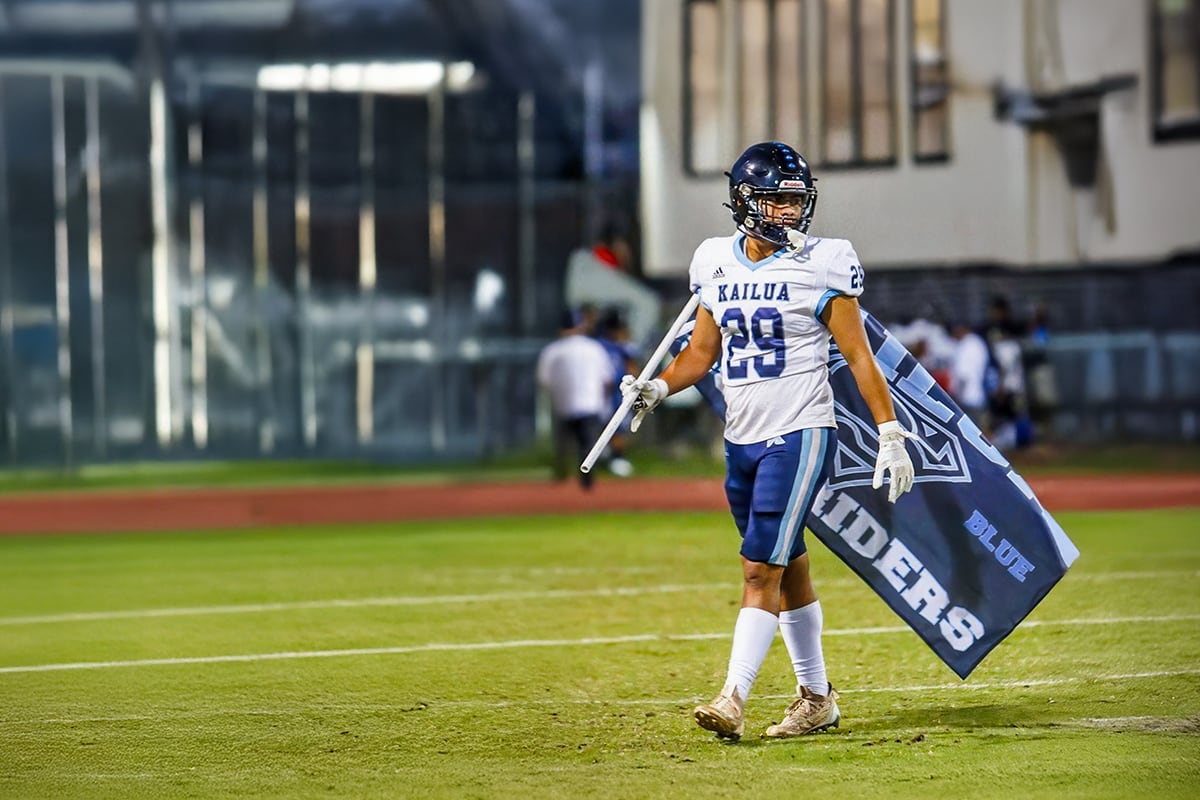 football player holding flag