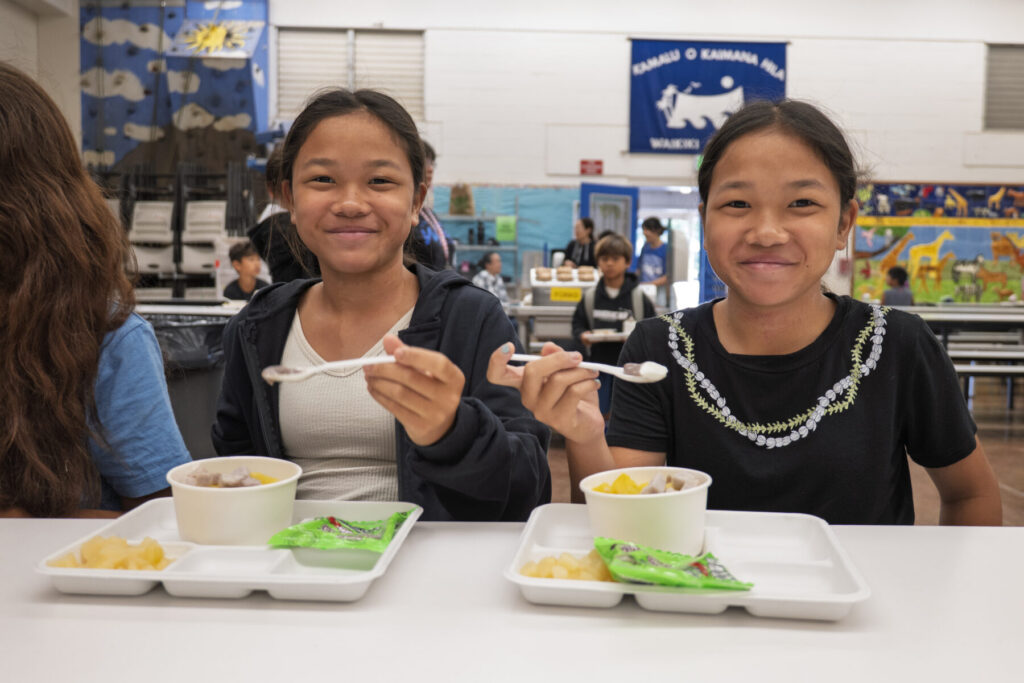 Two students smiling