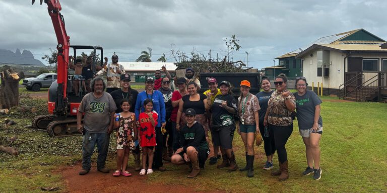 Group photo in front of heavy machinery equipment