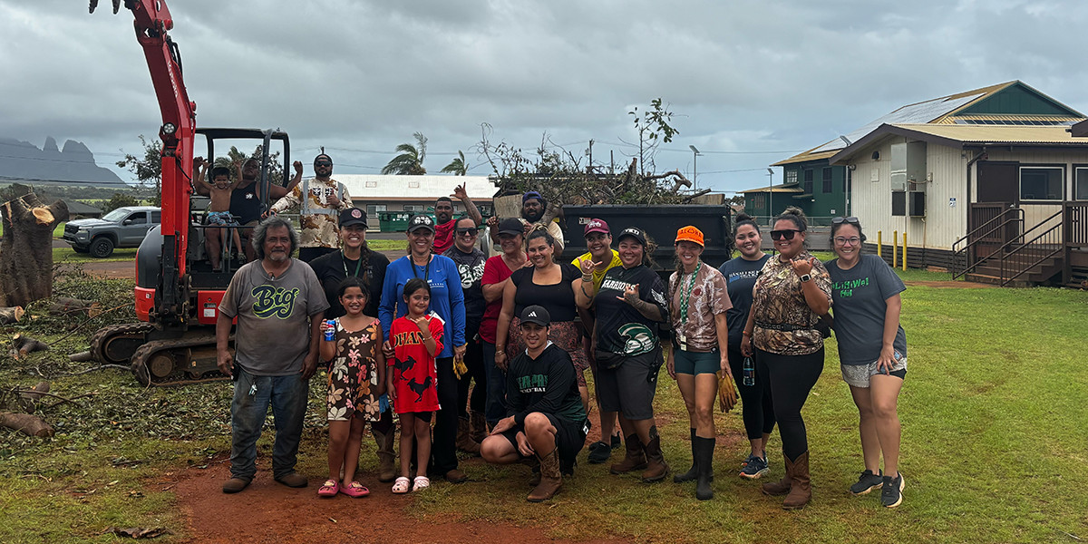 Group photo in front of heavy machinery equipment