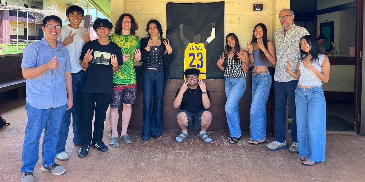 Kapa'a High School's Calculus II class poses together in front of a banner counting down the number of days until graduation on April 21, 2026.