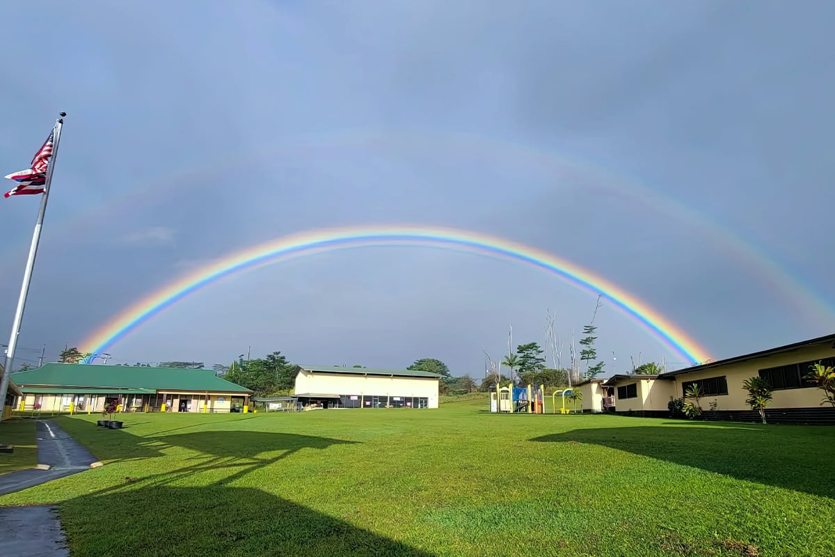 shot of campus with rainbow in background