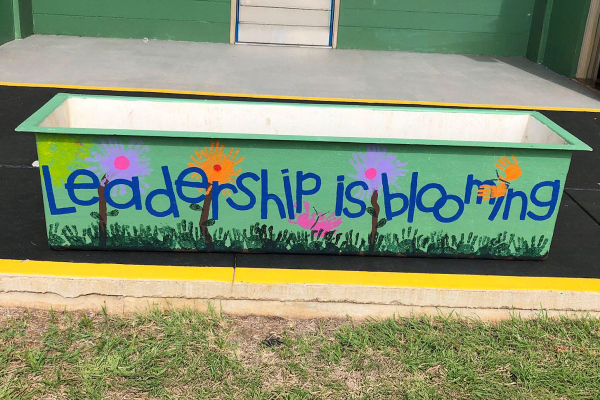 planter with the words leadership is blooming