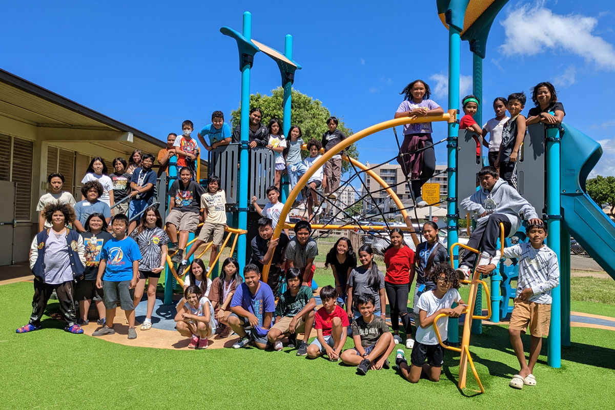 group shot of students on playground equipment