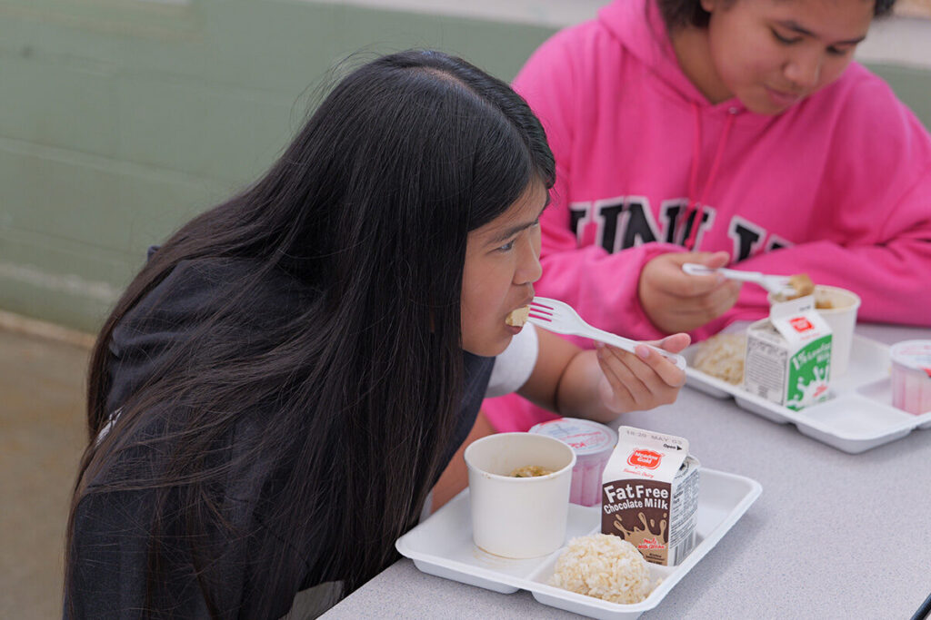 A Kailua Elementary student eats tofu poke in the cafeteria.