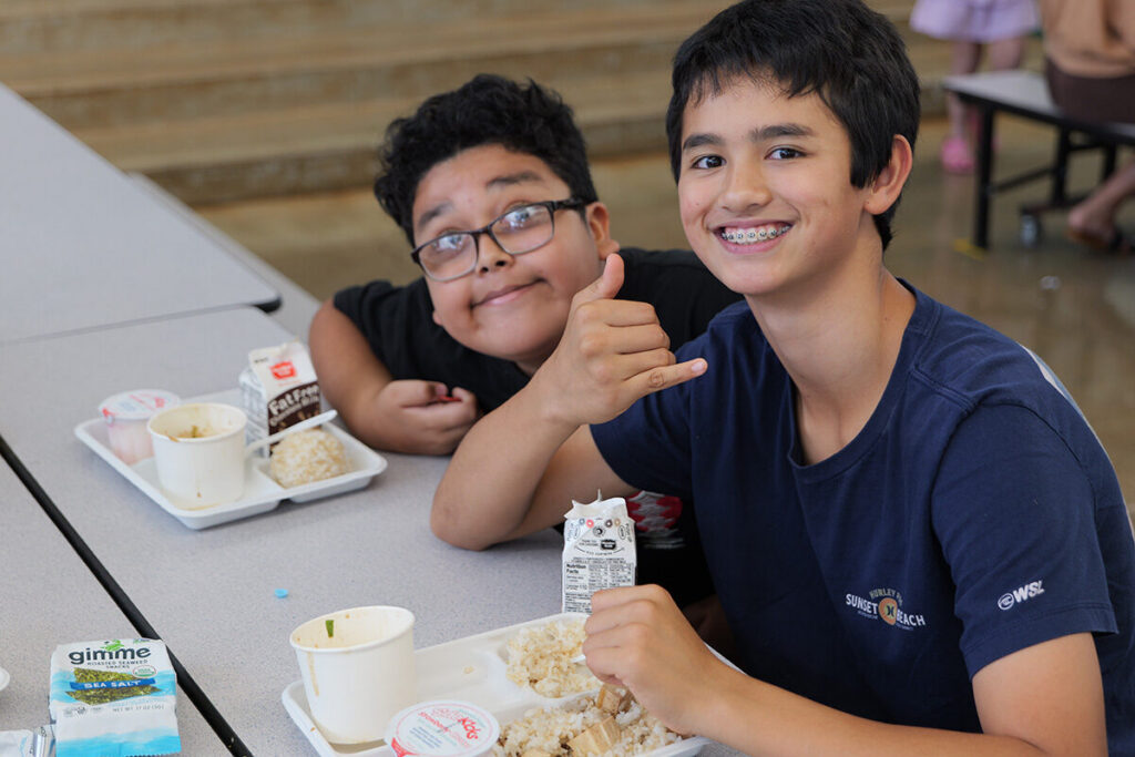 A Kailua Elementary student enjoys tofu poke in the cafeteria.