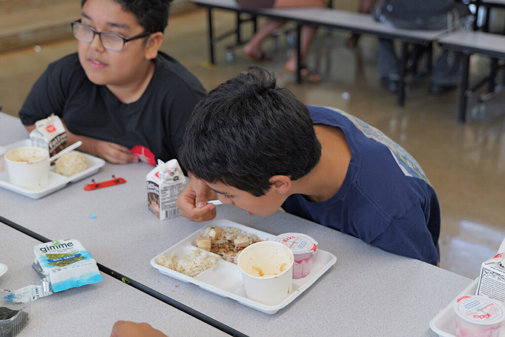 A Kailua Elementary student eats tofu poke in the cafeteria.