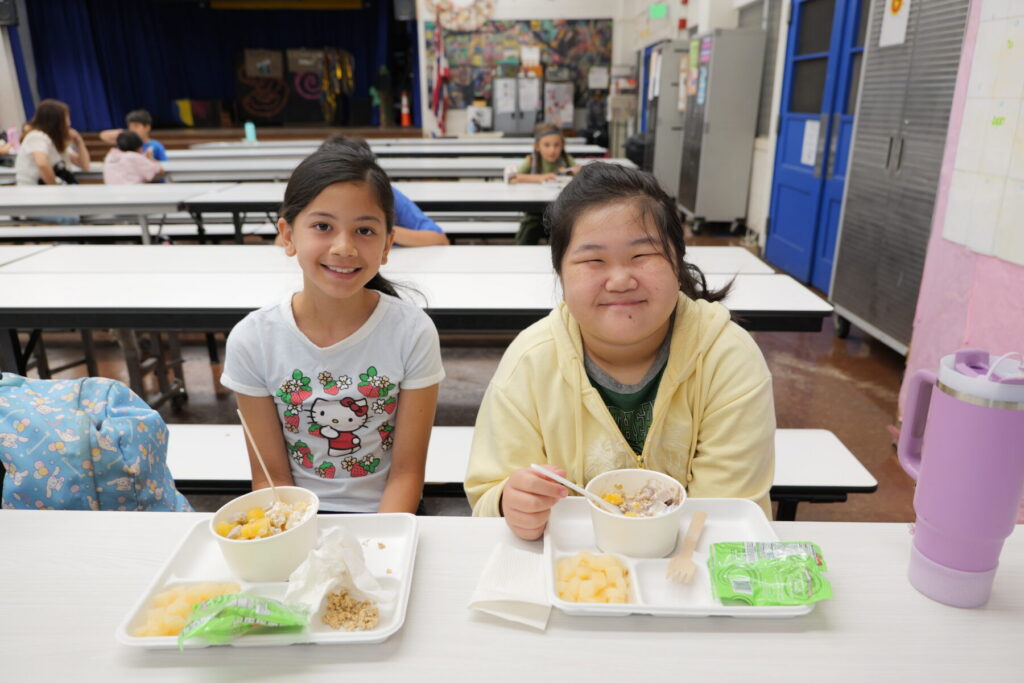 Two students smiling