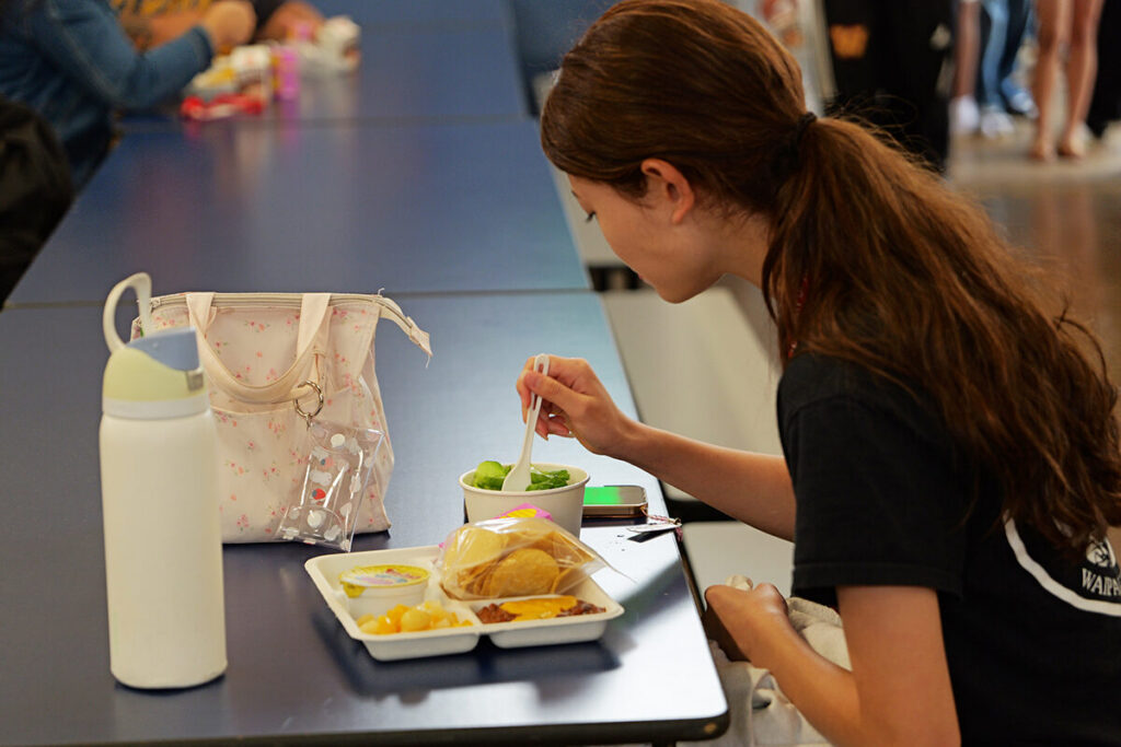 A student eats lunch in the Waipahu High School cafeteria.