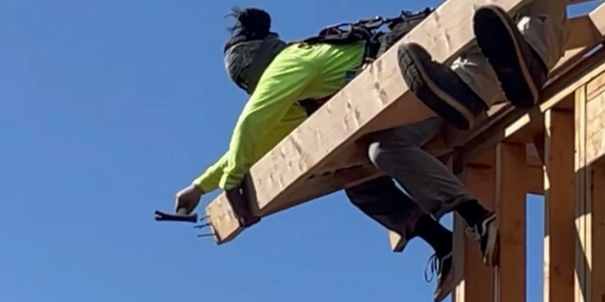 Carpenter hammers nail