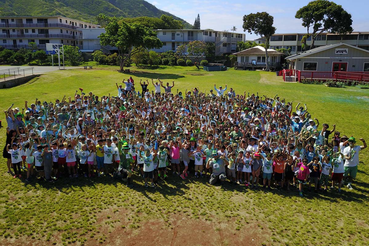 large group of waikiki elementary students and staff on a grass field
