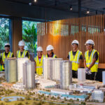Ten students behind scale model of Ward Village