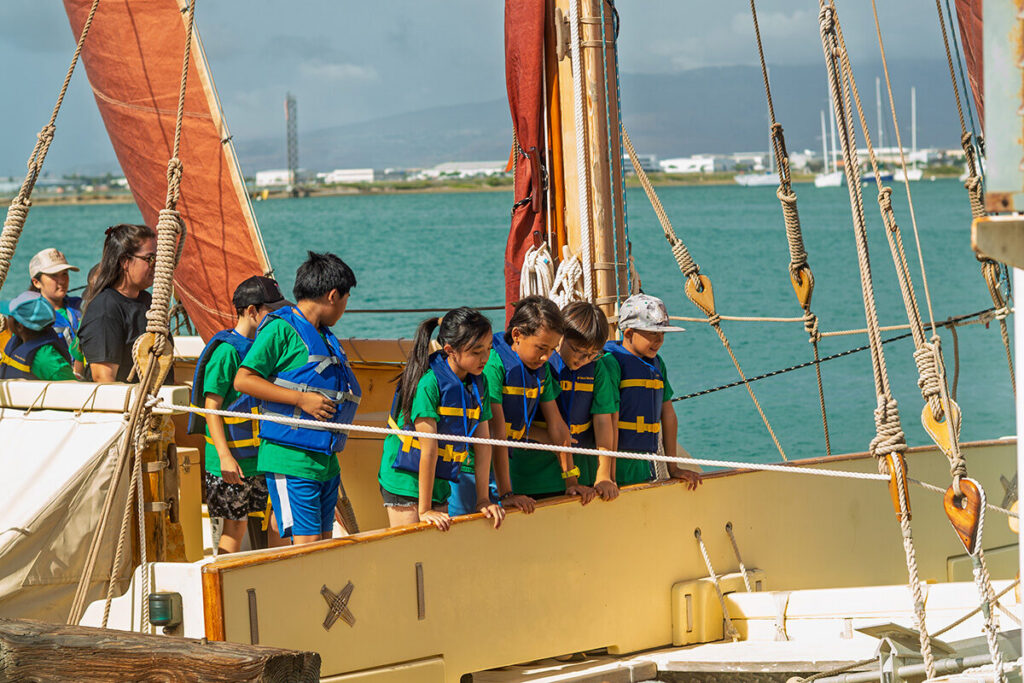 Wilson Elementary students look over the side of a canoe.